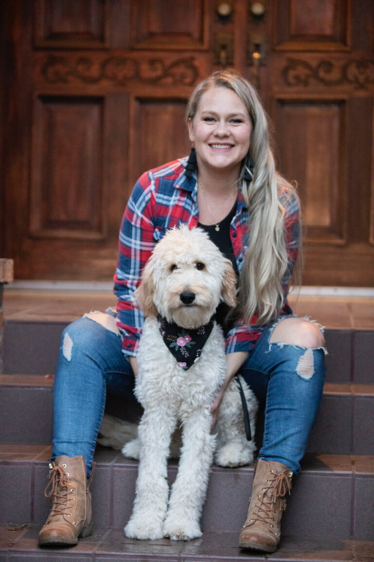Woman sitting with an Owen-a-Doodle Goldendoodle, representing the Guardian Home Program in Enumclaw, Washington